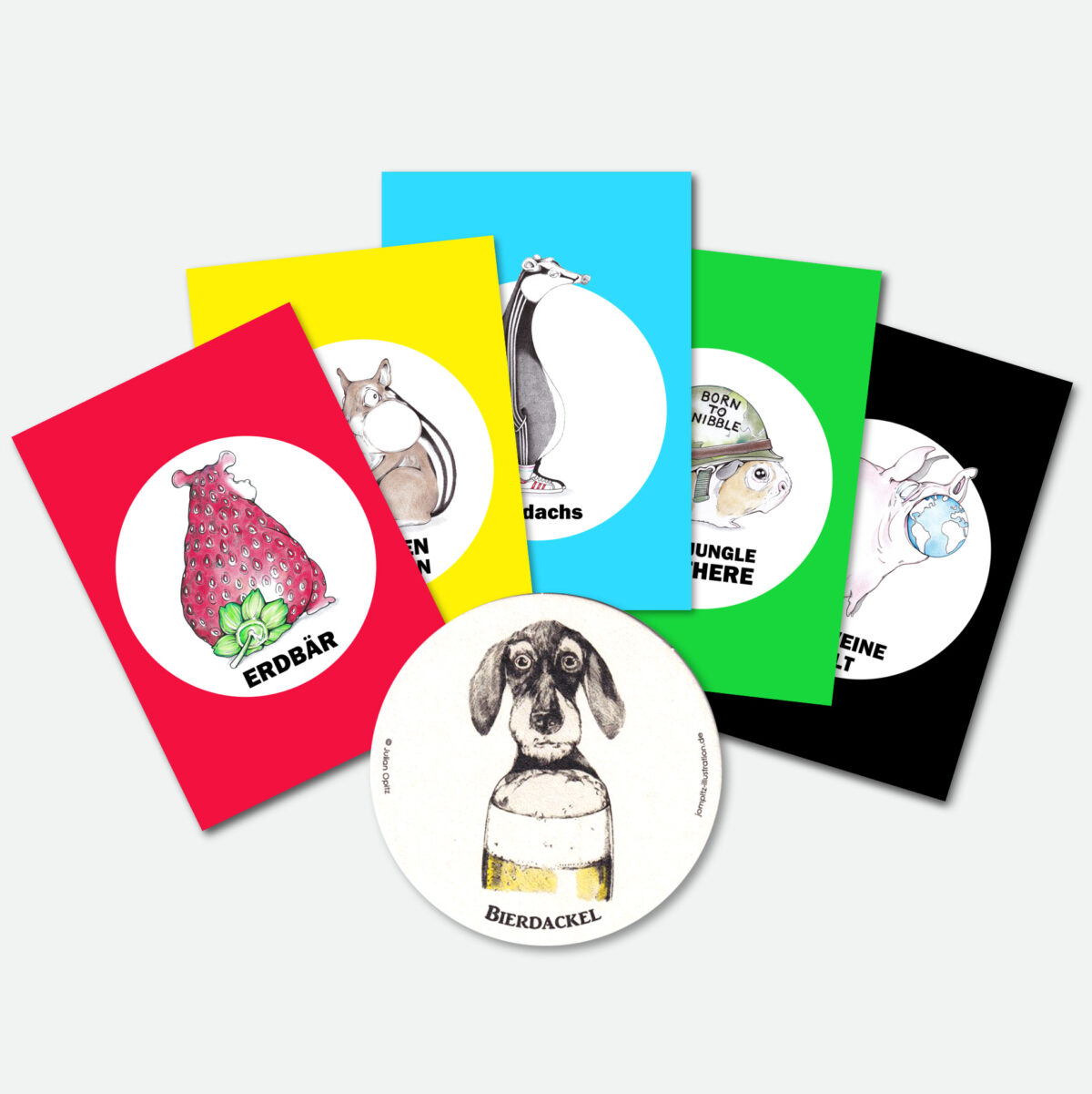 Das Gratis-Geschenk für deine Bestellung bei julian-opitz.de: ein Set bunter Postkarten und ein illustrierter Bierdackel.